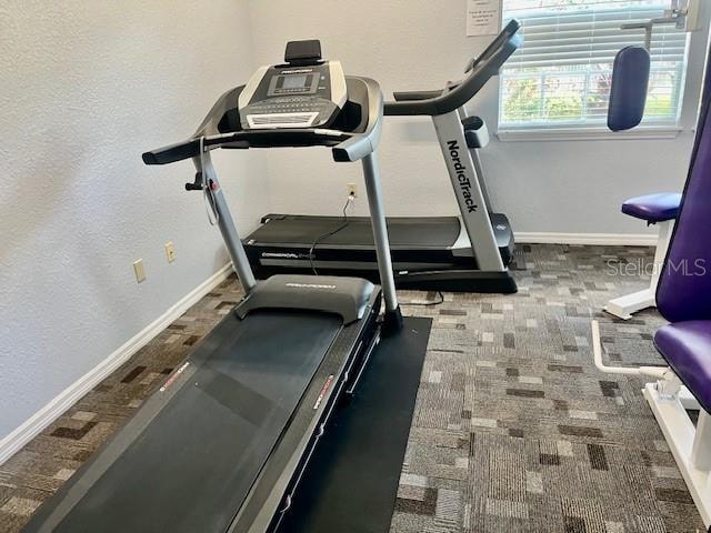 workout room with dark carpet