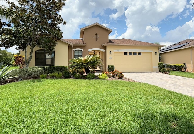 view of front of property featuring a garage and a front lawn