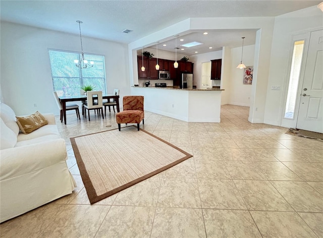 tiled living room featuring a notable chandelier