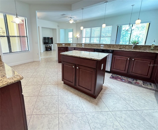 kitchen with dishwasher, decorative light fixtures, and sink