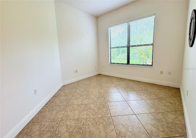 unfurnished room with light tile patterned floors