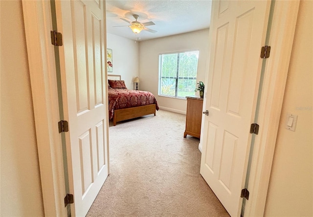 bedroom with ceiling fan and carpet