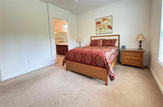 carpeted bedroom featuring ensuite bath