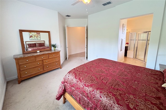 bedroom with light carpet, ensuite bathroom, and ceiling fan