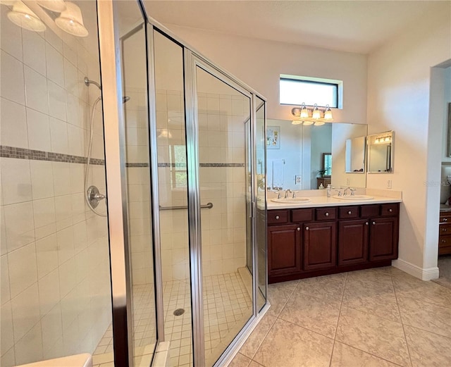 bathroom with tile patterned floors, vanity, and walk in shower