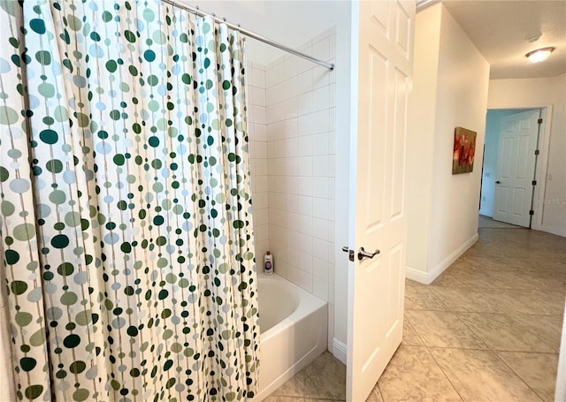 bathroom with tile patterned flooring and shower / bath combo