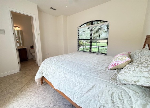 tiled bedroom featuring ensuite bathroom