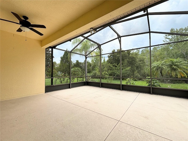 view of patio / terrace featuring glass enclosure and ceiling fan