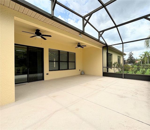 view of patio / terrace featuring ceiling fan and a lanai