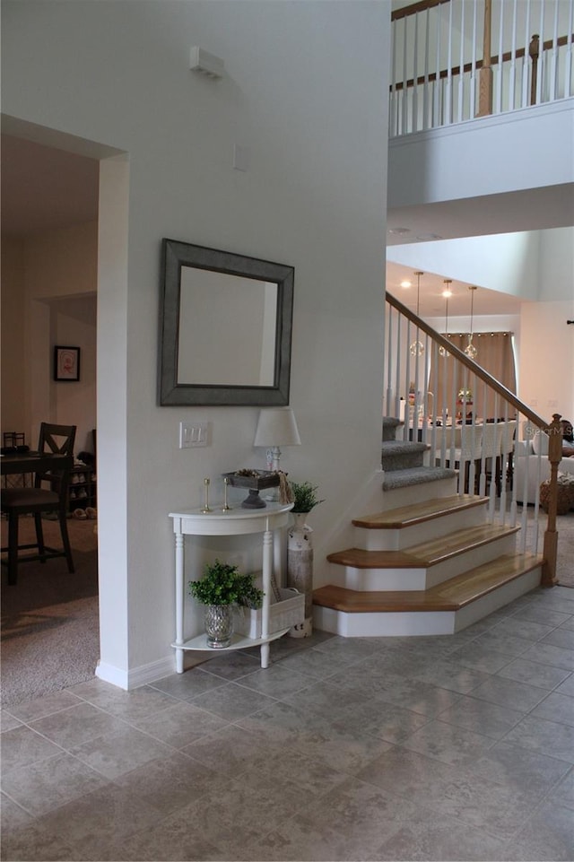 stairs featuring a high ceiling