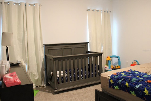 bedroom featuring light carpet