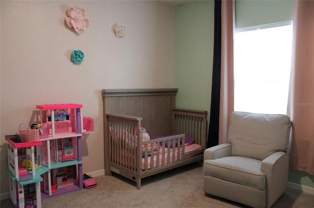 carpeted bedroom with a crib