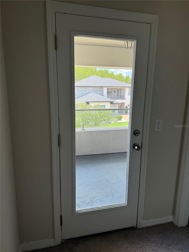 doorway to outside featuring carpet floors