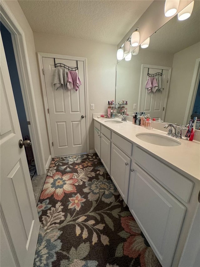 bathroom with vanity and a textured ceiling