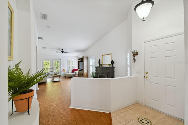 tiled entrance foyer featuring ceiling fan and lofted ceiling