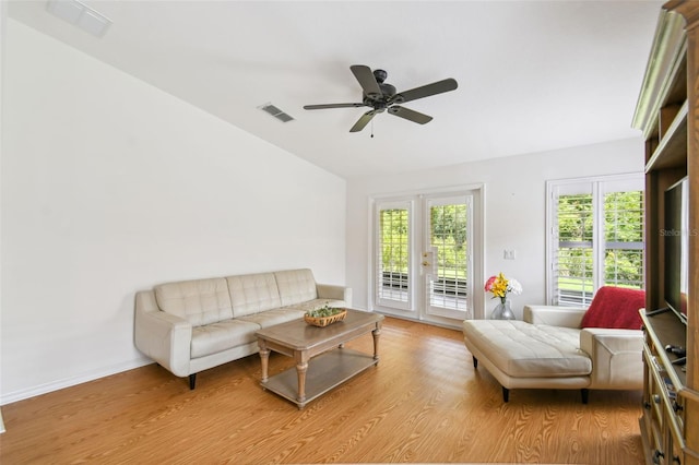 living room featuring ceiling fan, french doors, and light hardwood / wood-style floors