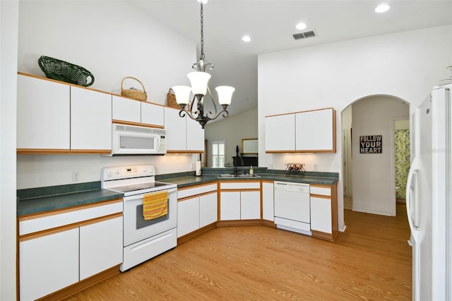 kitchen featuring sink, light hardwood / wood-style floors, lofted ceiling, white appliances, and white cabinets