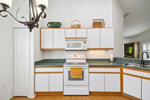 kitchen with white cabinetry, sink, white appliances, and light hardwood / wood-style flooring