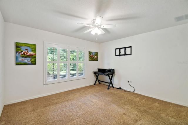 spare room with carpet floors and ceiling fan