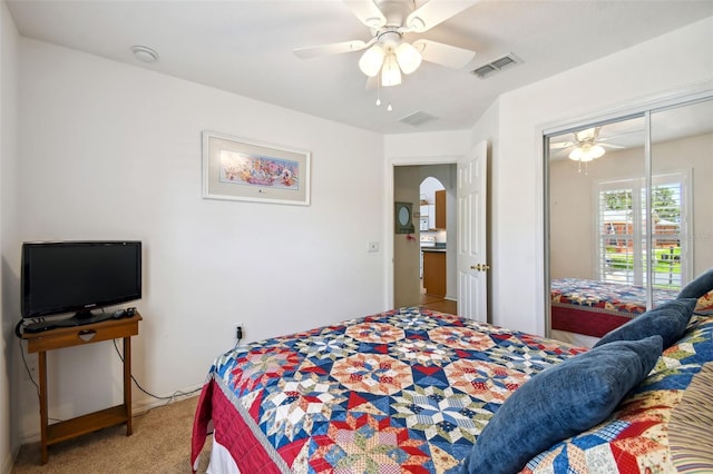 carpeted bedroom with a closet and ceiling fan