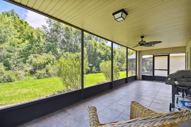 unfurnished sunroom with ceiling fan