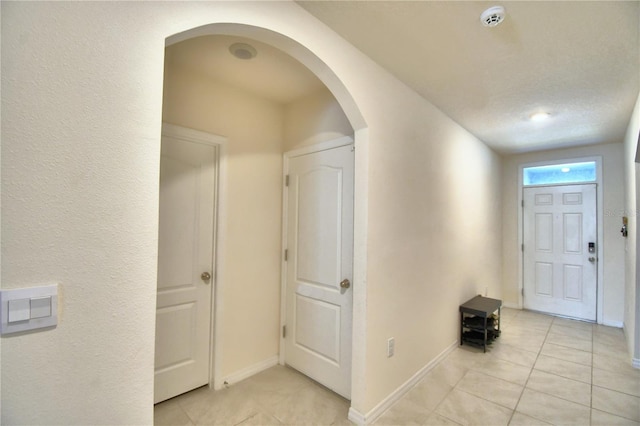 tiled foyer featuring a textured ceiling