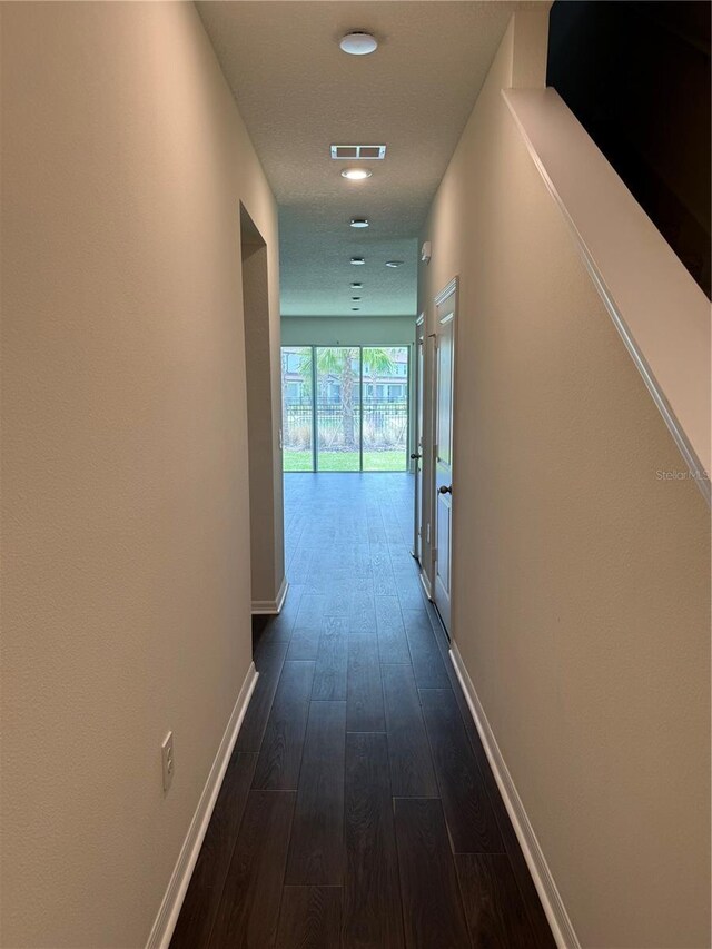 corridor with dark wood-type flooring