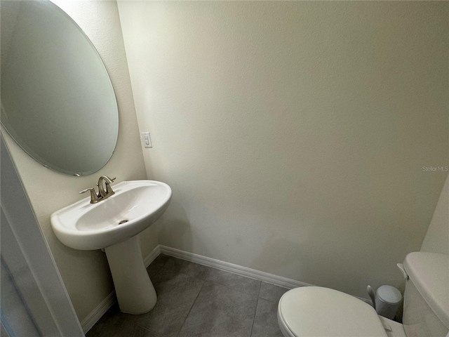 bathroom with tile patterned flooring and toilet