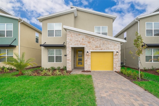 view of front facade with a garage and a front lawn