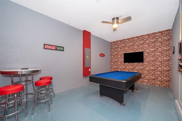 rec room with brick wall, electric panel, ceiling fan, and billiards