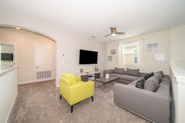 living room featuring carpet and ceiling fan