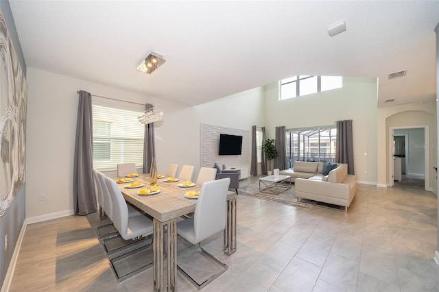 tiled dining room featuring plenty of natural light