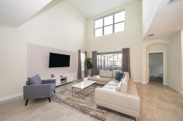 living room featuring plenty of natural light and high vaulted ceiling