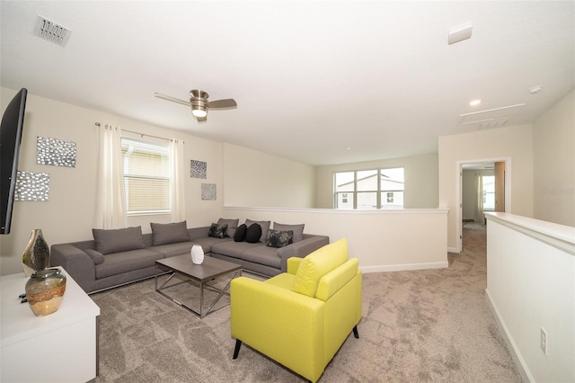 living room featuring carpet floors and ceiling fan