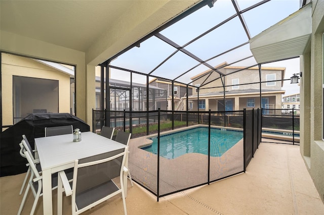 view of swimming pool with a patio area and a lanai