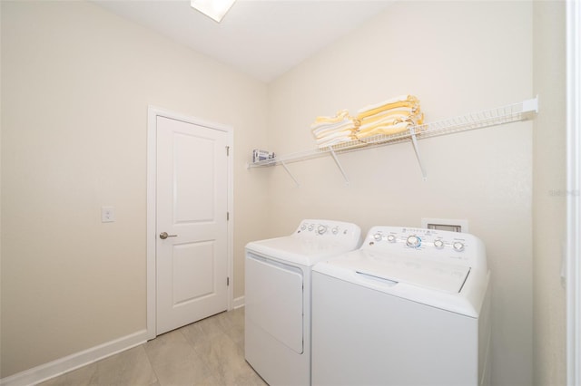 washroom with washer and dryer and light tile patterned floors