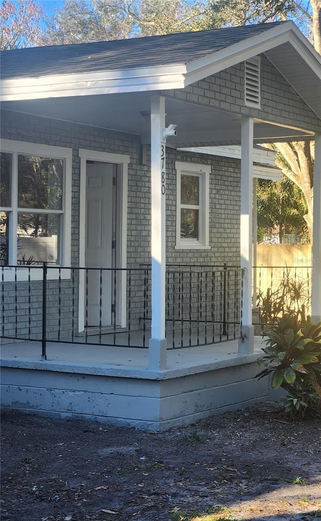 view of side of home with a porch