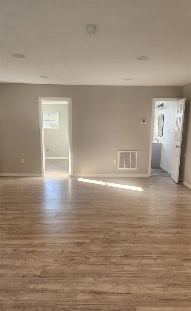 unfurnished room with hardwood / wood-style flooring