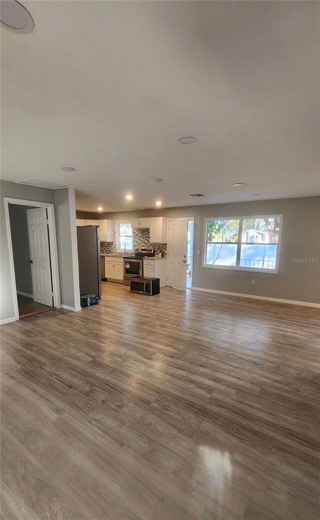 unfurnished living room with wood-type flooring