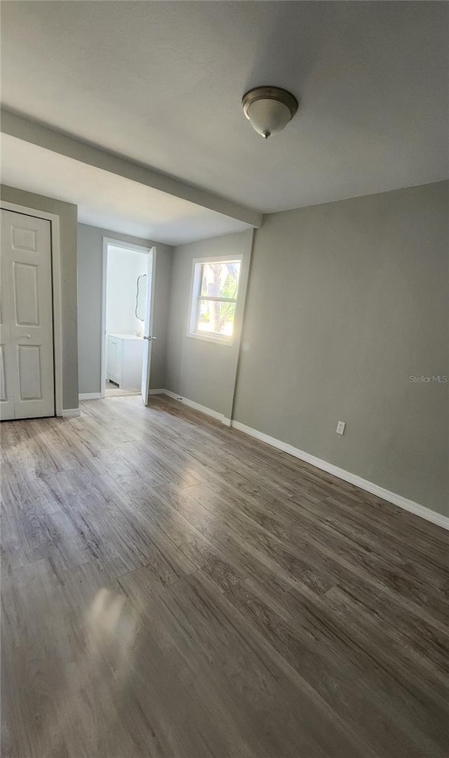 spare room featuring dark hardwood / wood-style flooring