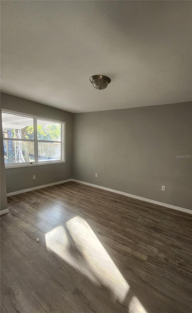 empty room featuring dark hardwood / wood-style flooring