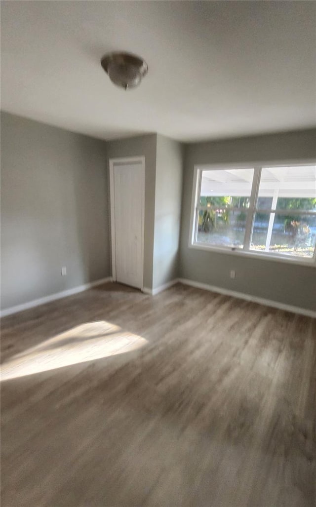 unfurnished bedroom with hardwood / wood-style floors