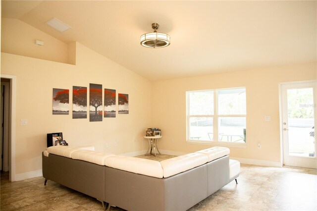 living room with vaulted ceiling and plenty of natural light