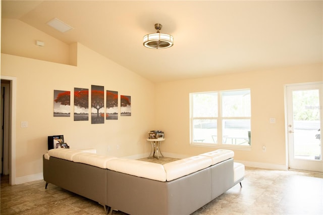 living area with lofted ceiling and baseboards