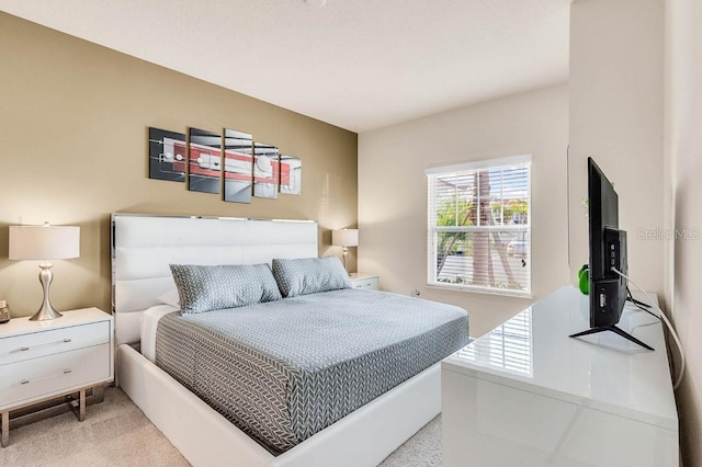 bedroom featuring light carpet