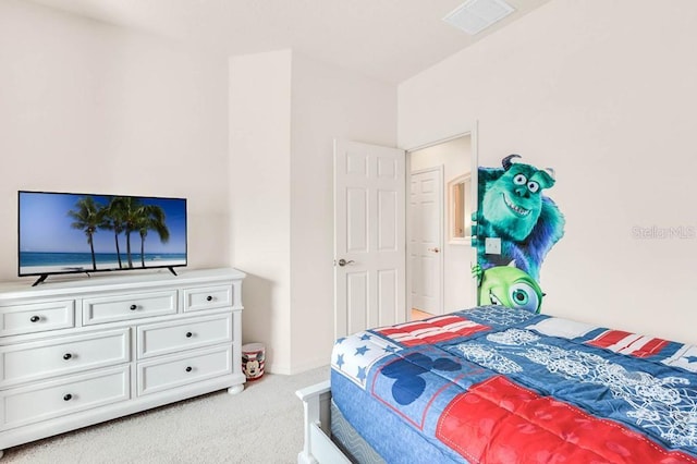 carpeted bedroom featuring visible vents