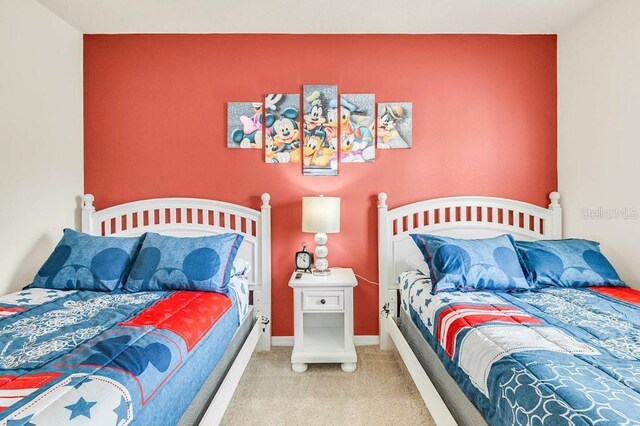 bedroom featuring carpet floors and baseboards