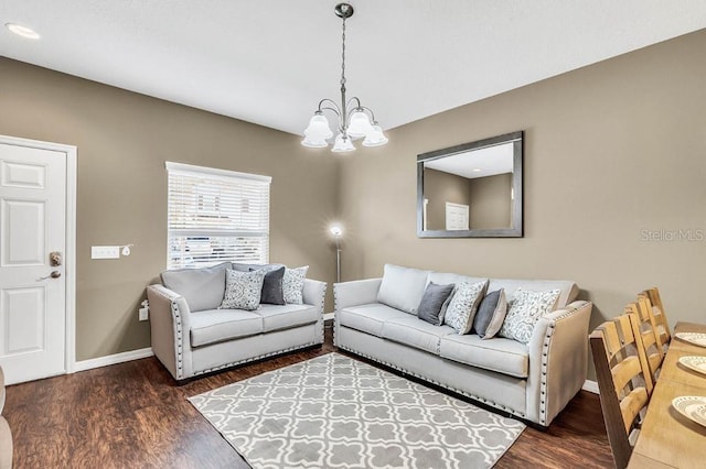 living room featuring dark hardwood / wood-style flooring and a notable chandelier