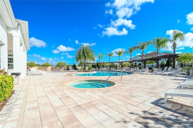 view of pool with a community hot tub and a patio area