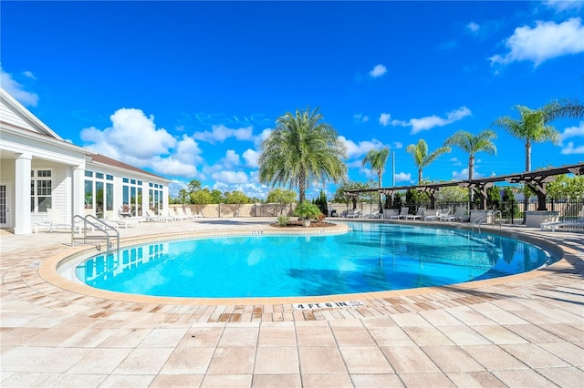 community pool featuring a patio and fence